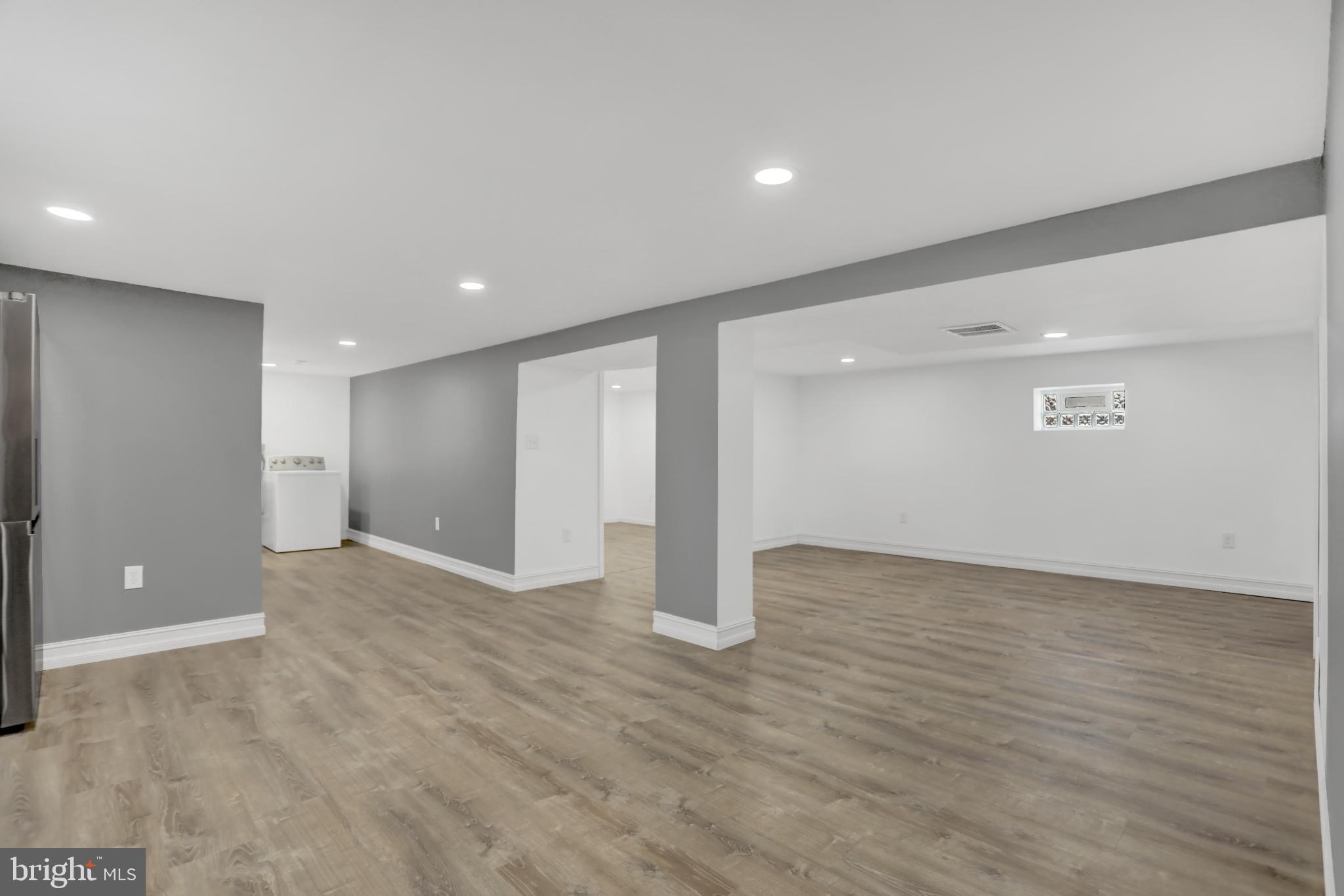 9036 Simms Court Parkville, MD 21234 - Photo 34 of 52 an empty room with wooden floor and windows