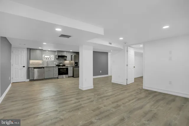 a workspace with furniture and a wooden floor