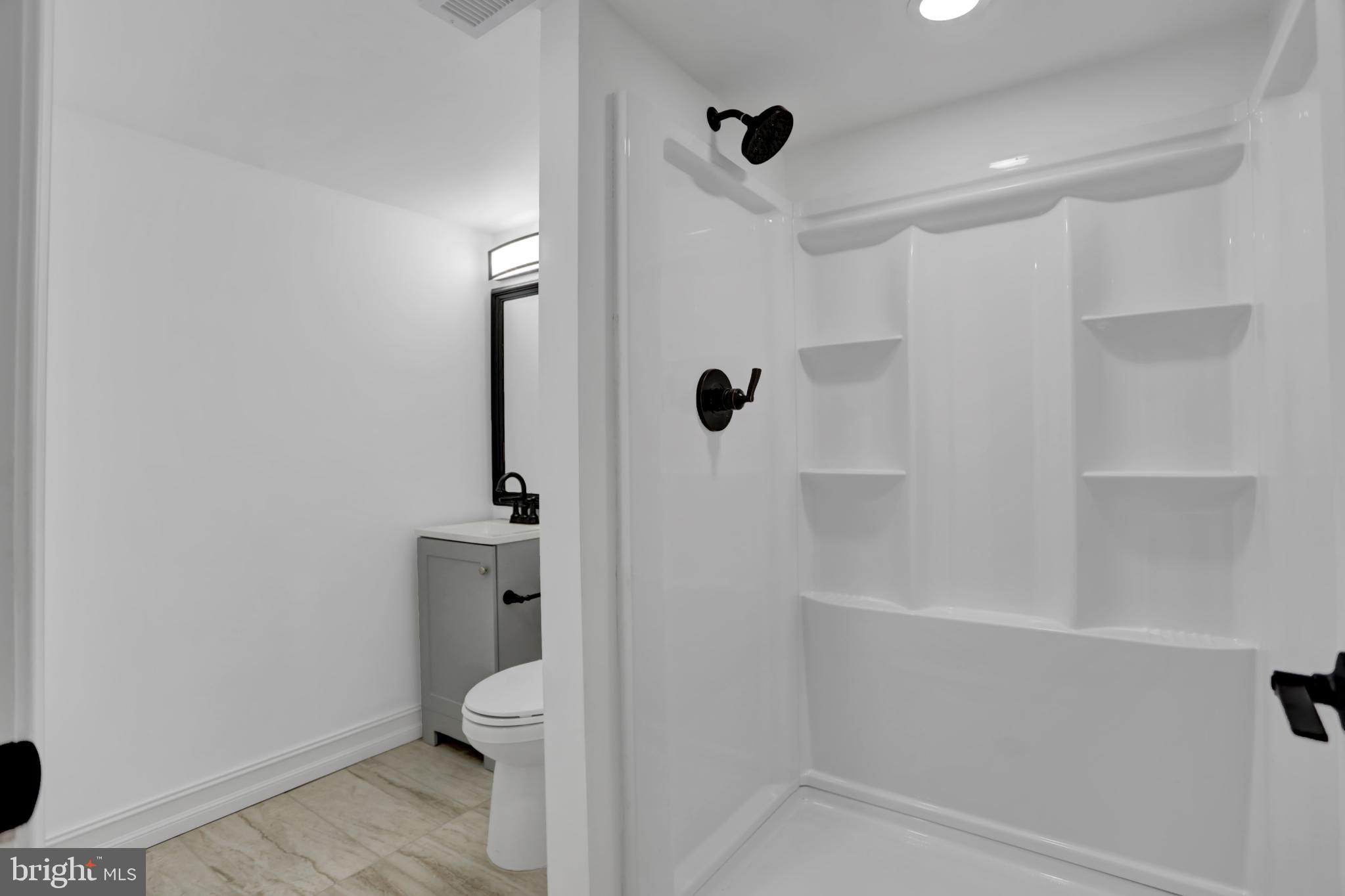 9036 Simms Court Parkville, MD 21234 - Photo 41 of 52 a bathroom with a shower a toilet and a sink