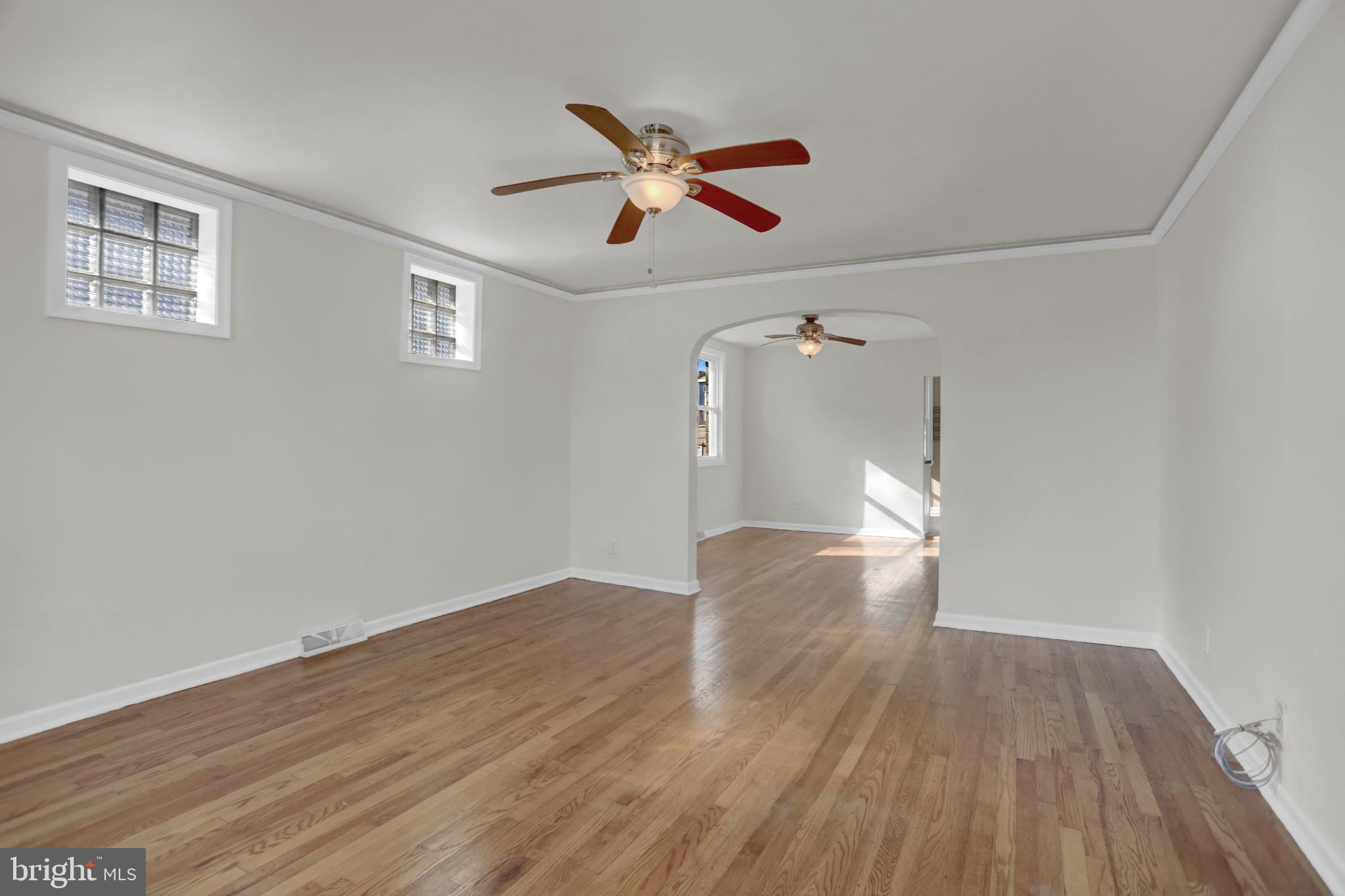 9036 Simms Court Parkville, MD 21234 - Photo 5 of 52 a view of empty room with wooden floor and ceiling fan