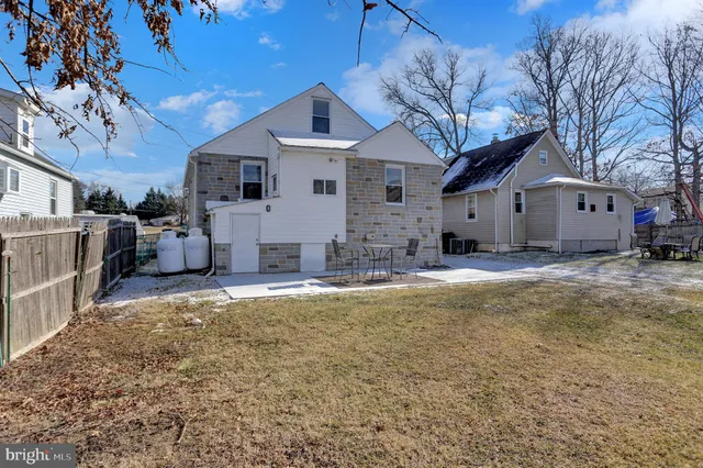 a view of a house with swimming pool and sitting area