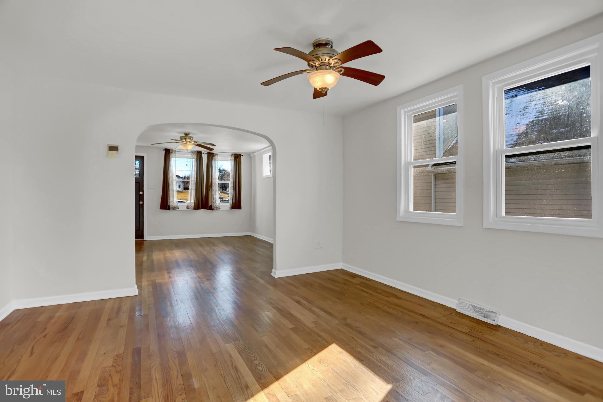 9036 Simms Court Parkville, MD 21234 - Photo 7 of 52 a view of a livingroom with wooden floor and a ceiling fan