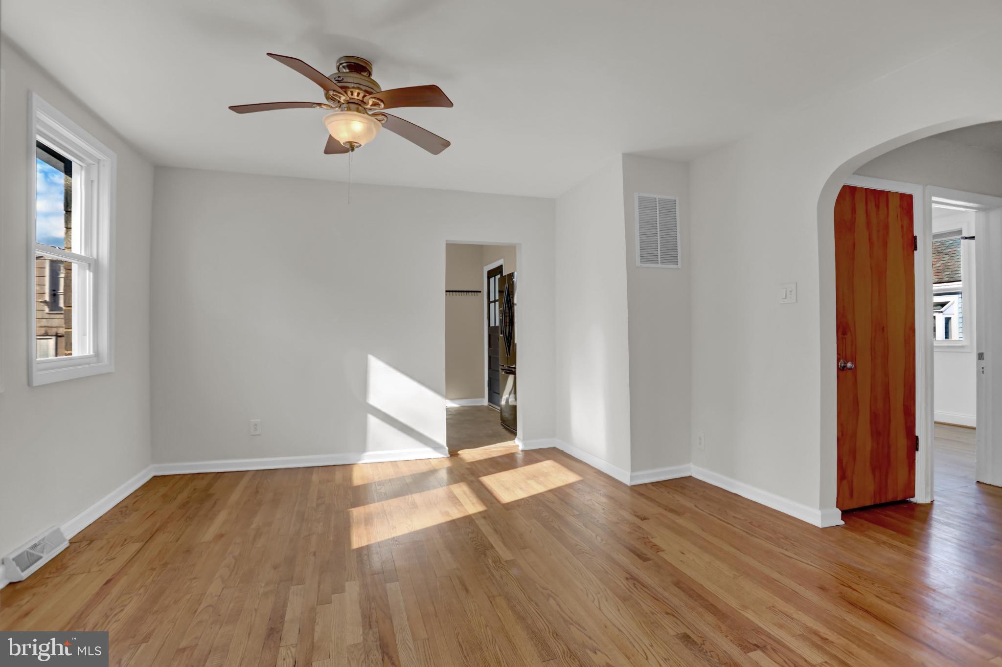 9036 Simms Court Parkville, MD 21234 - Photo 9 of 52 wooden floor in an empty room with a window