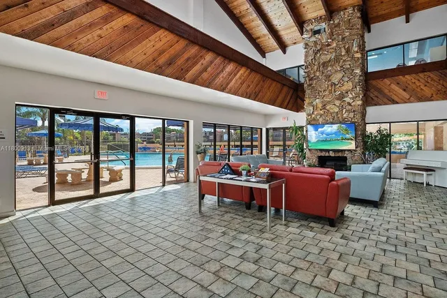 a living room with fireplace furniture and a large window