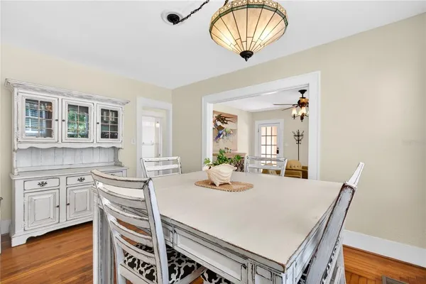 a kitchen with a table chairs and wooden floor