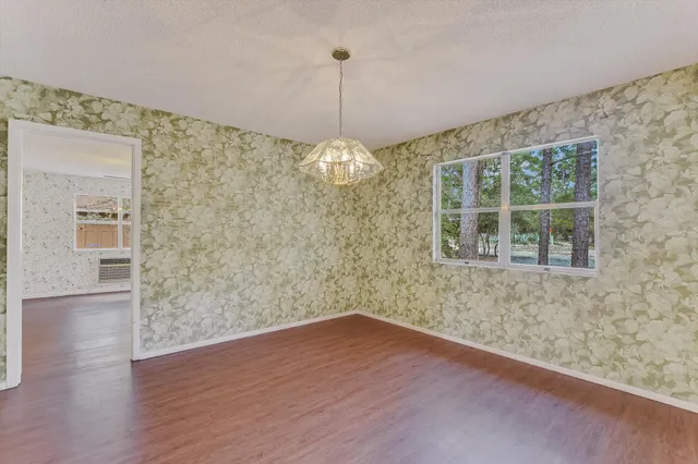 a view of a room with wooden floor and windows