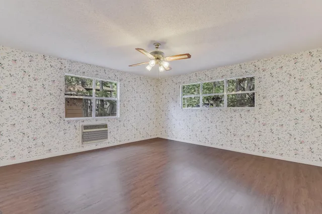 wooden floor in an empty room with a window