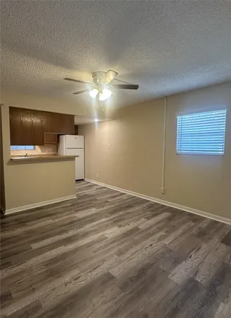 a view of a livingroom with a dishwasher cabinets and wooden floor