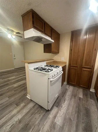a view of kitchen with cabinets and wooden floor