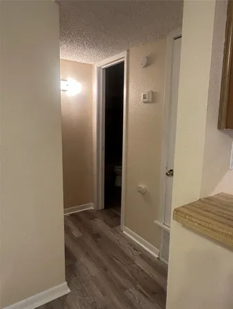 a view of hallway with wooden floor