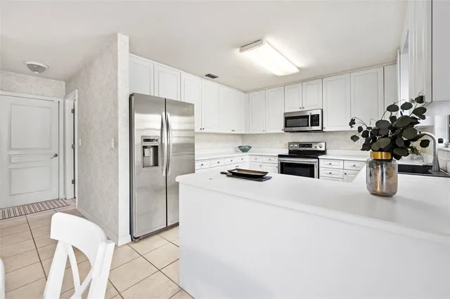 a kitchen with stainless steel appliances kitchen island granite countertop a stove a sink and a microwave