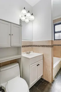 a bathroom with a sink a toilet and mirror