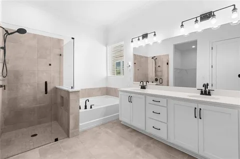 a spacious bathroom with a double vanity sink mirror and shower