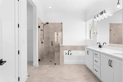 a spacious bathroom with a shower a sink and a mirror