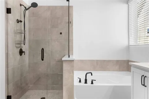 a bathroom with a bathtub and shower