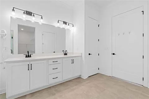 a spacious bathroom with a double vanity sink mirror and