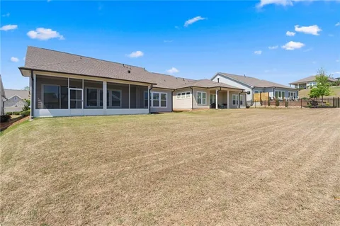 a view of a house with a yard and sitting space