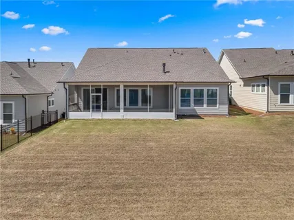 an aerial view of a house with outdoor space and pool