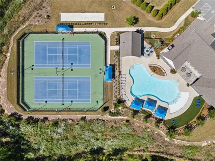 a view of a tennis ground with a small pool