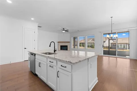 a kitchen with sink stove and refrigerator