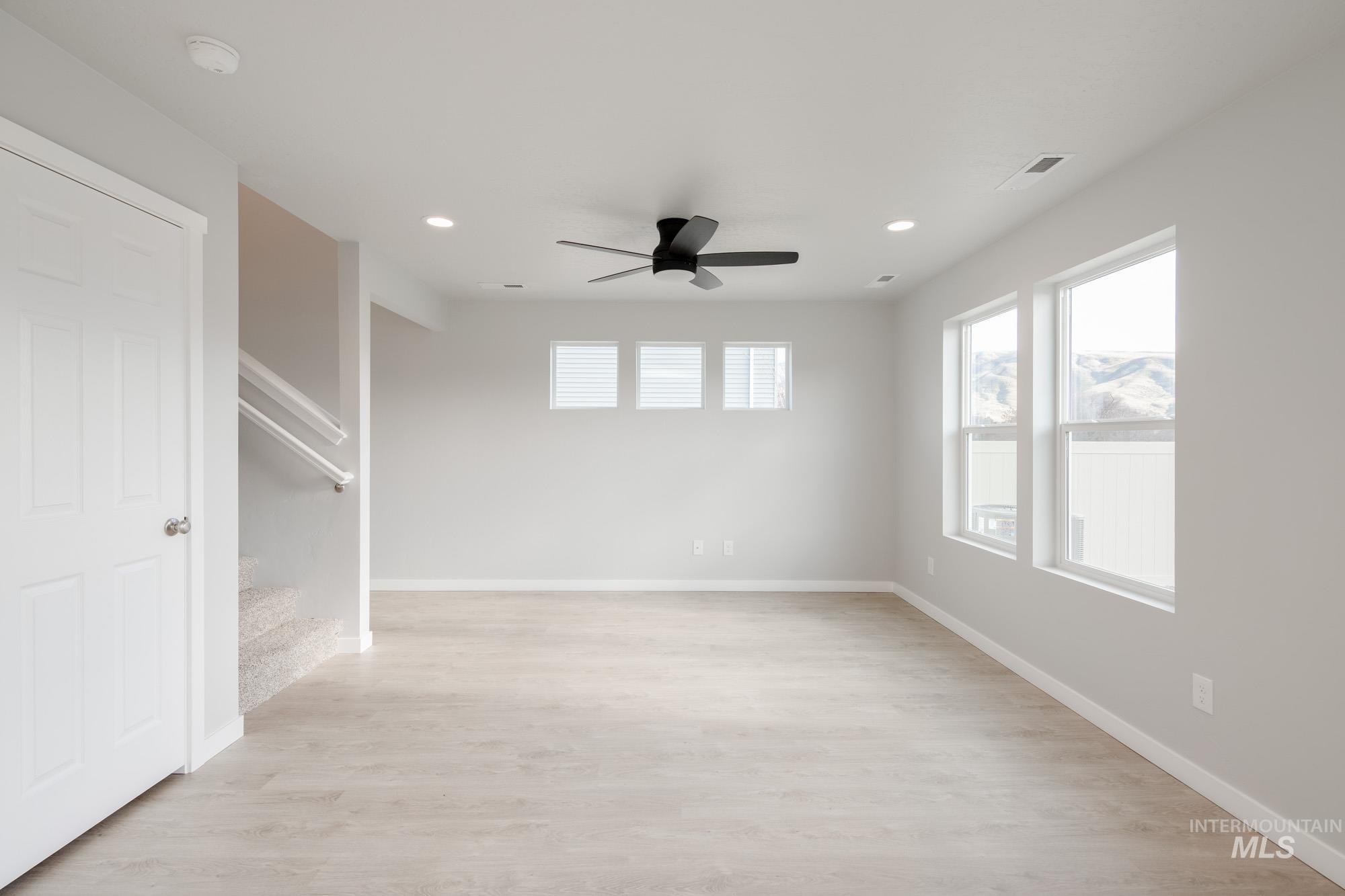 10788 Rutland Street Caldwell, ID 83605 - Photo 11 of 22 Unfurnished room featuring a ceiling fan, light wood finished floors, and recessed lighting