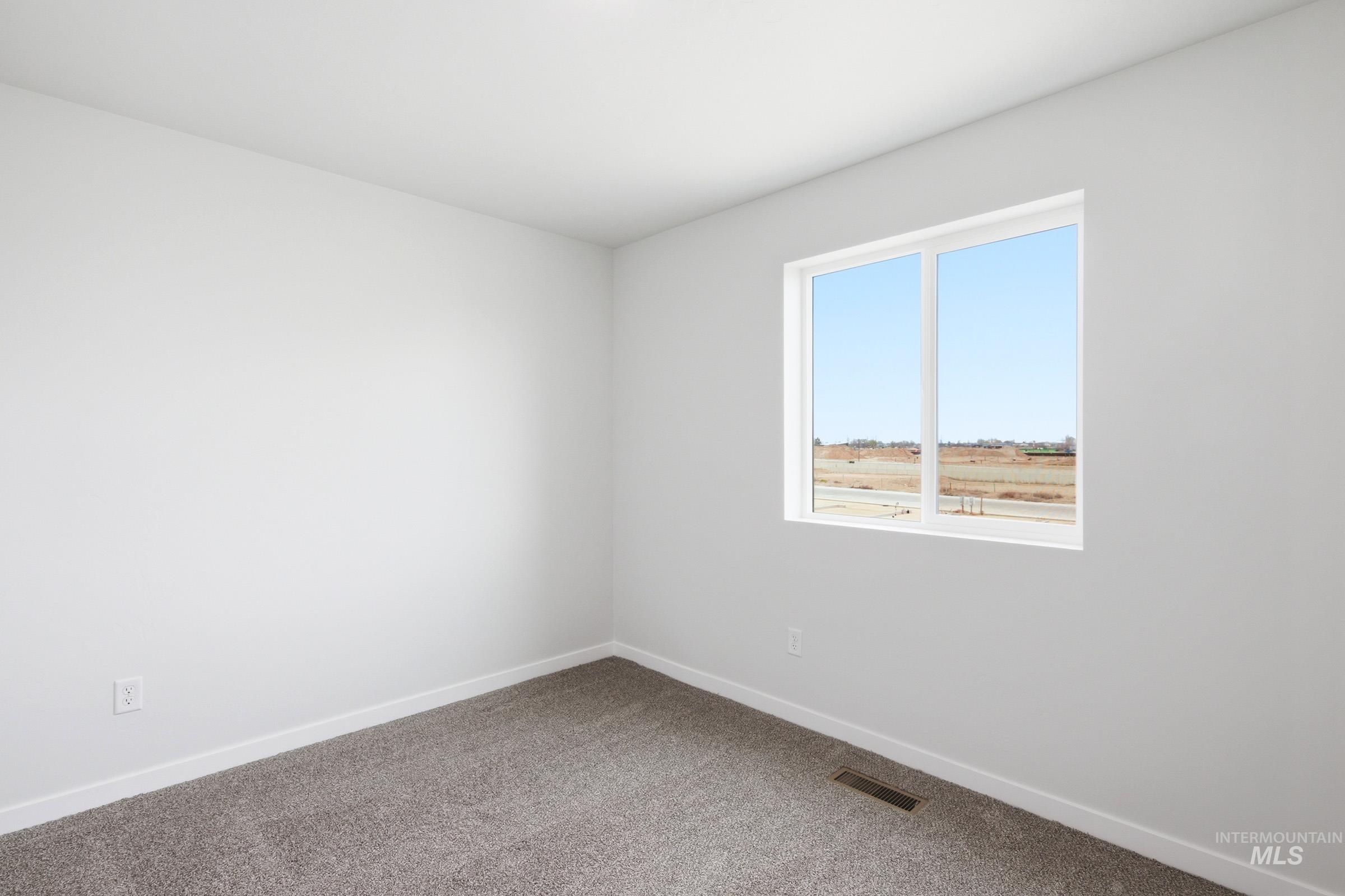 10788 Rutland Street Caldwell, ID 83605 - Photo 13 of 22 Empty room with carpet and baseboards
