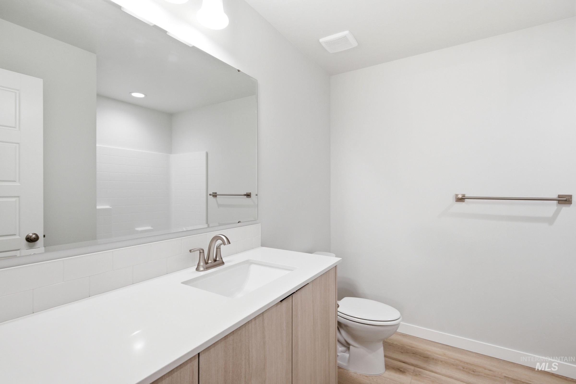 10788 Rutland Street Caldwell, ID 83605 - Photo 15 of 22 Full bathroom featuring vanity and light wood finished floors