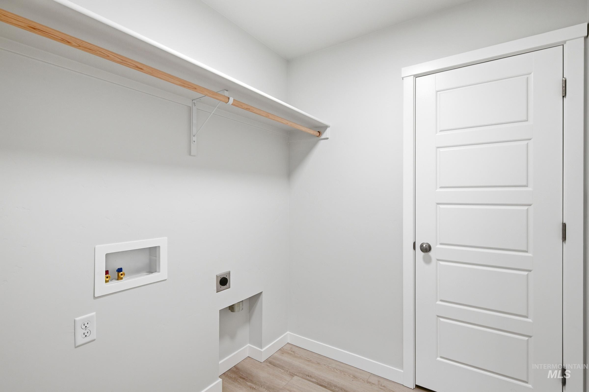 10788 Rutland Street Caldwell, ID 83605 - Photo 16 of 22 Laundry area with light wood finished floors, washer hookup, and electric dryer hookup