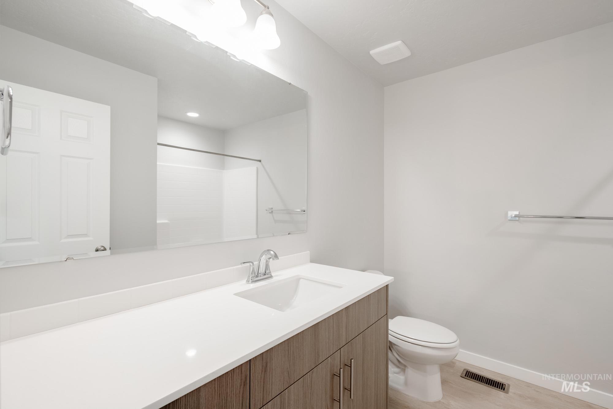 10788 Rutland Street Caldwell, ID 83605 - Photo 14 of 22 Bathroom featuring a shower, vanity, and light wood-style flooring