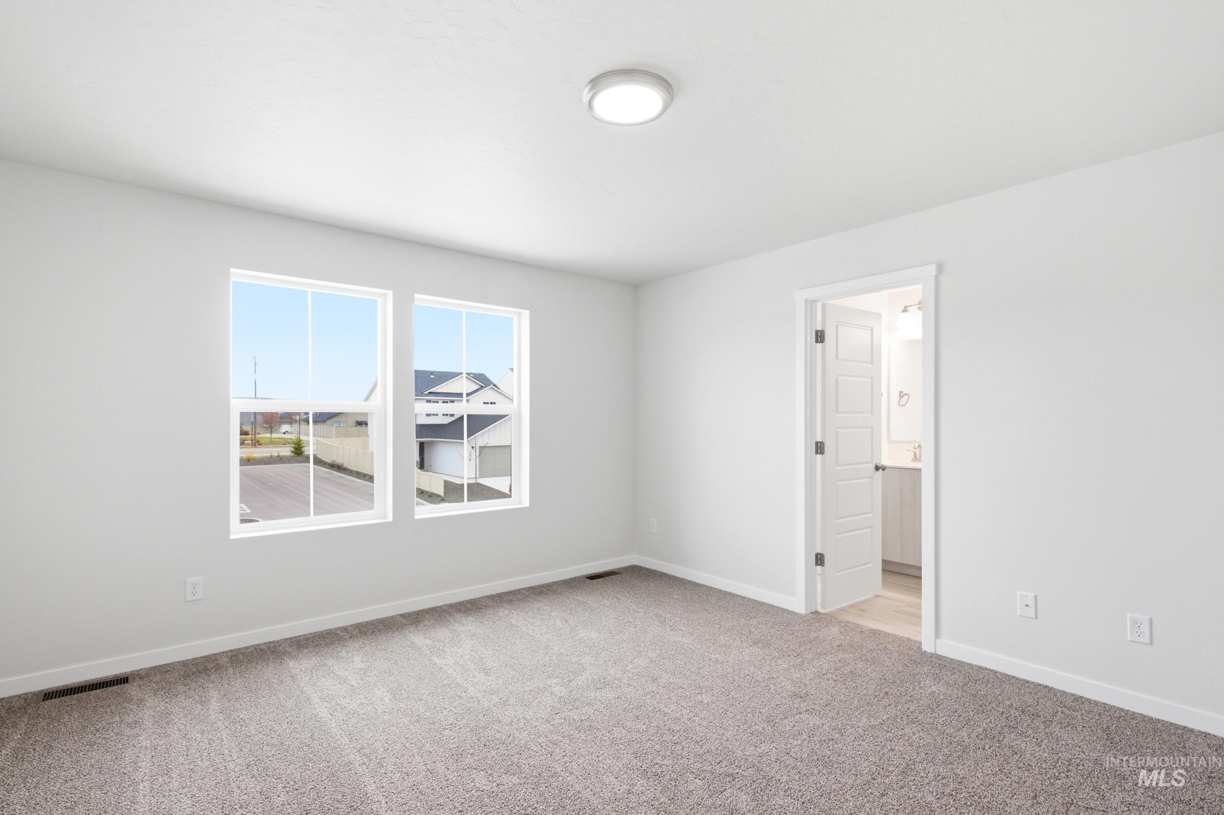 10788 Rutland Street Caldwell, ID 83605 - Photo 17 of 22 Spare room featuring baseboards and light colored carpet