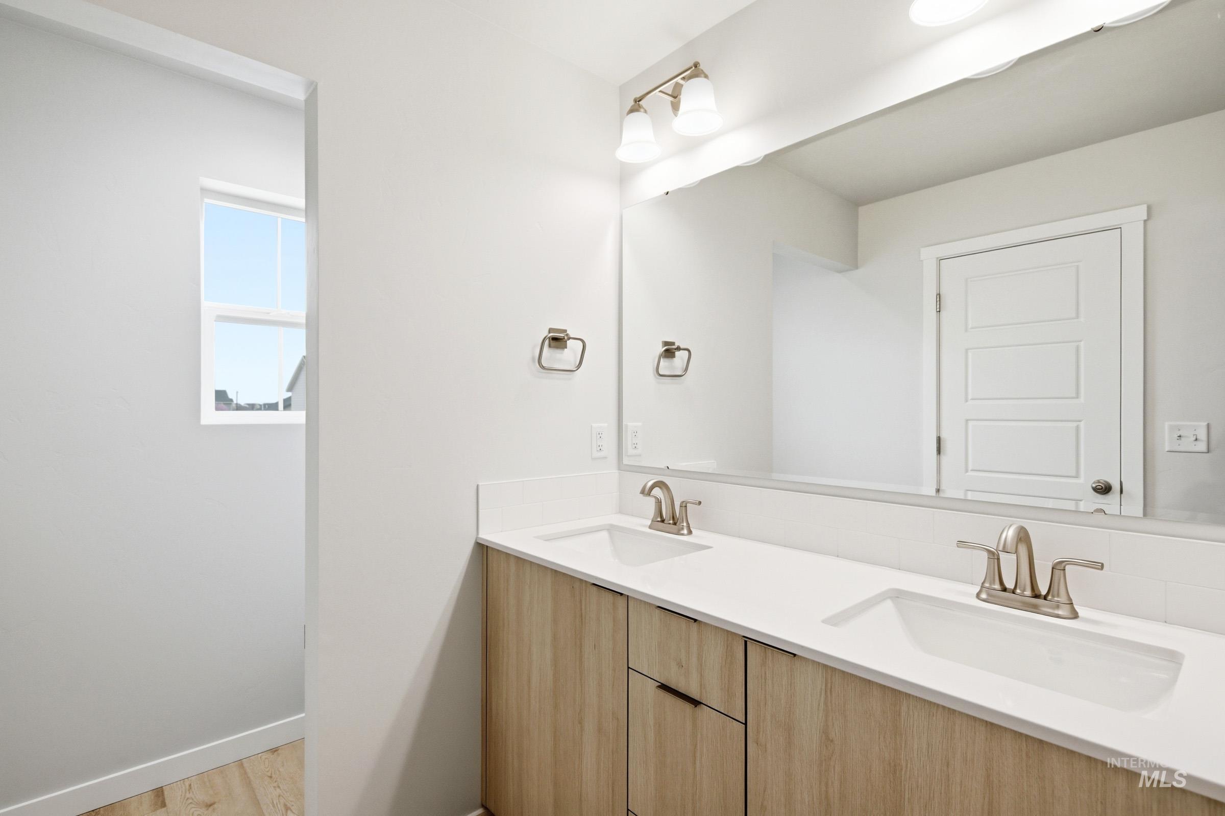 10788 Rutland Street Caldwell, ID 83605 - Photo 19 of 22 Bathroom featuring double vanity and light wood finished floors