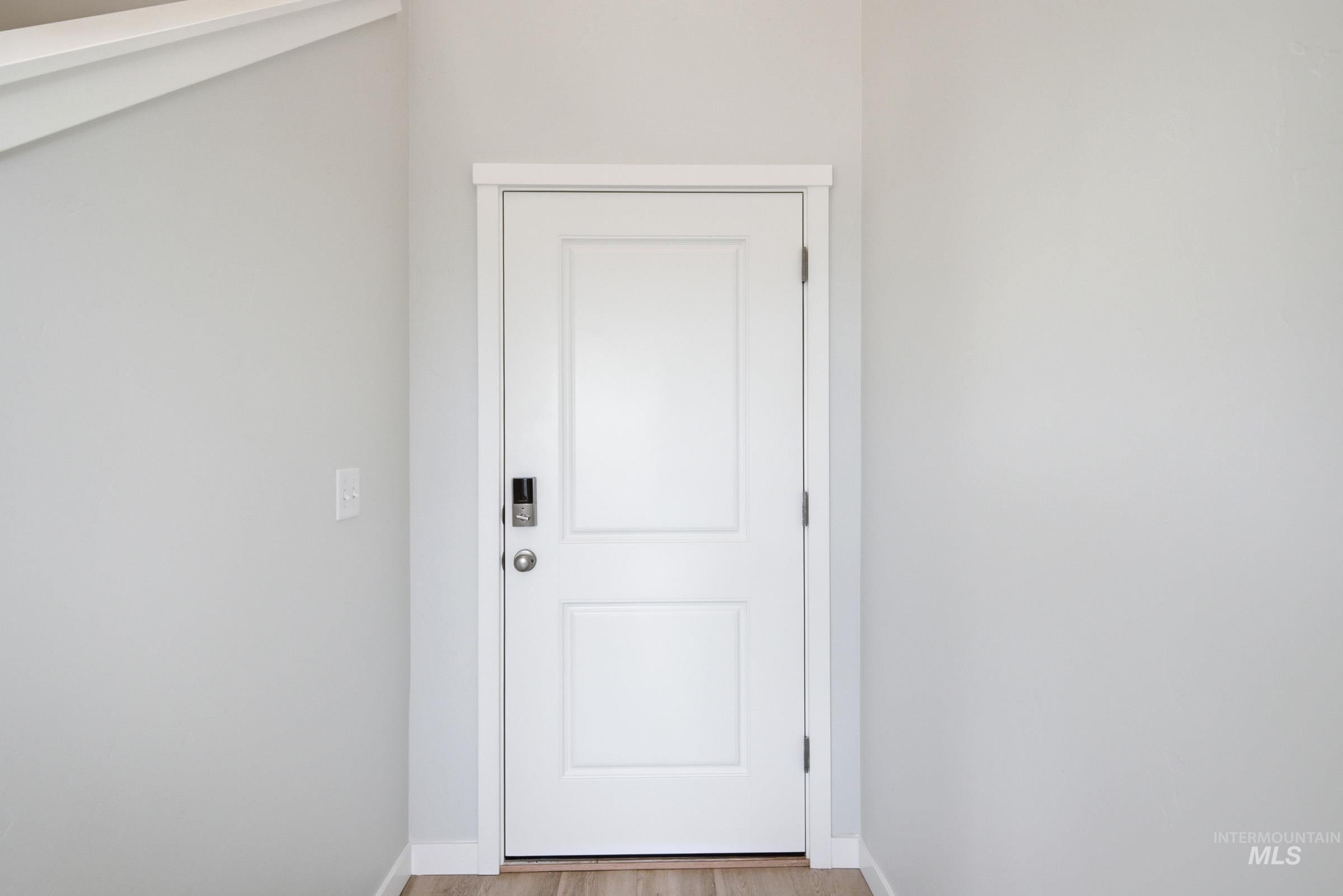 10788 Rutland Street Caldwell, ID 83605 - Photo 2 of 22 Doorway to outside featuring baseboards and wood finished floors