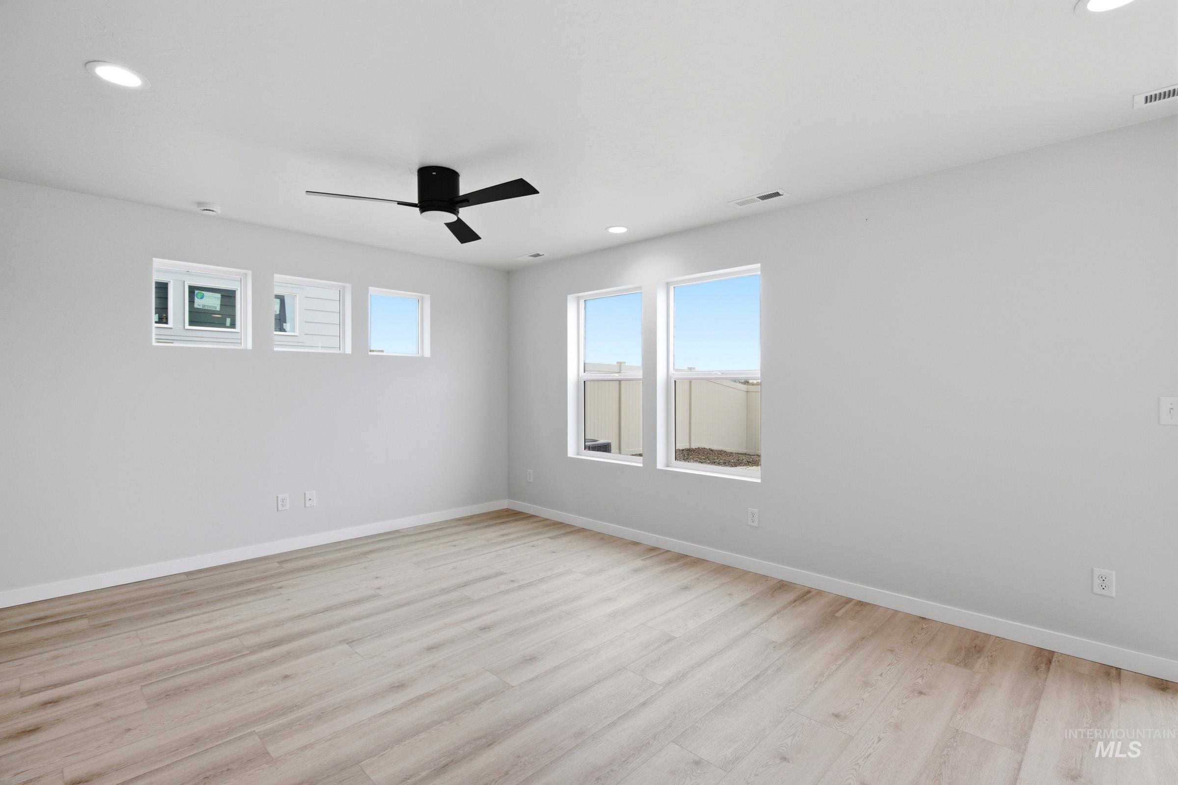 10788 Rutland Street Caldwell, ID 83605 - Photo 5 of 22 Unfurnished room with ceiling fan, light wood-type flooring, and recessed lighting