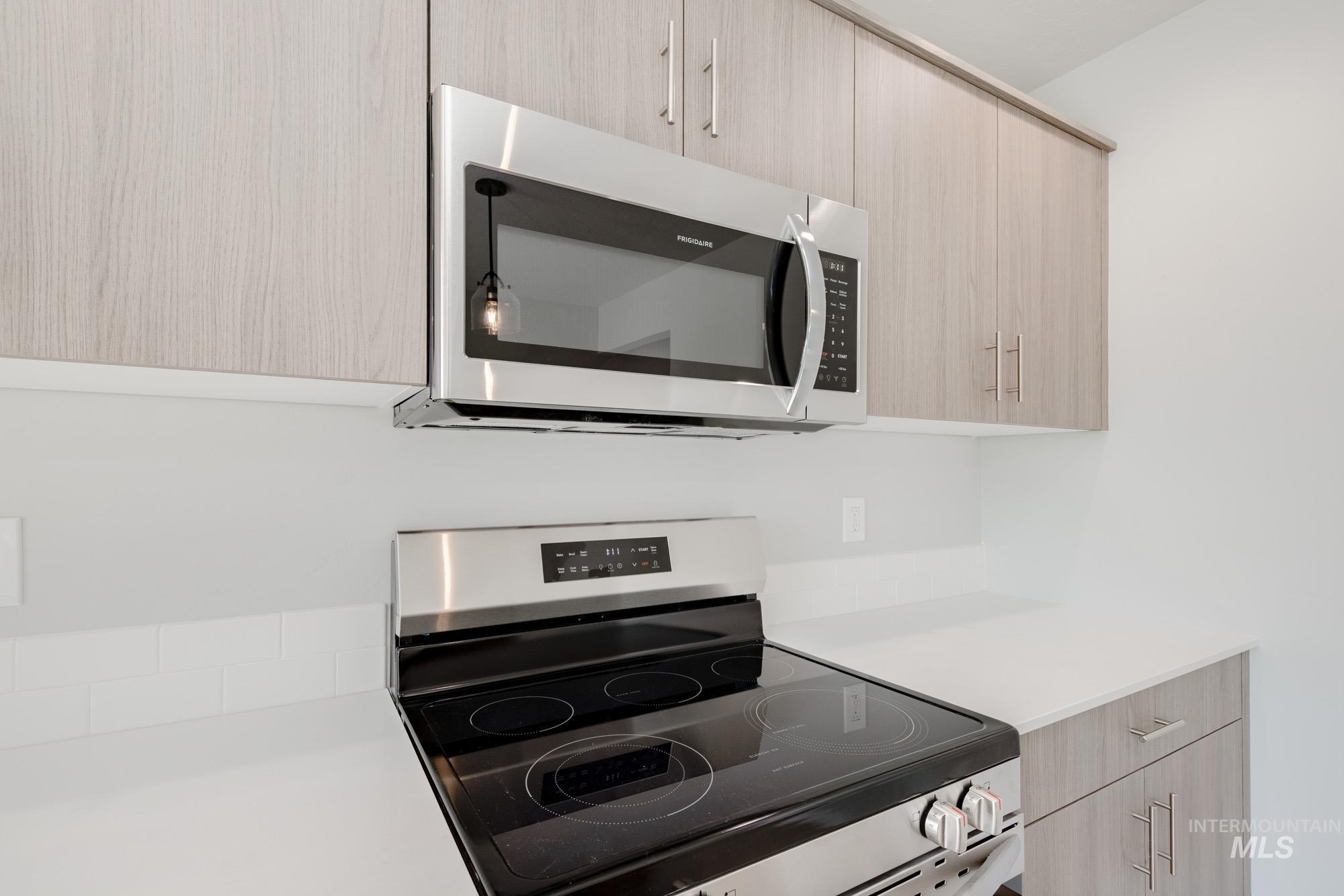 10788 Rutland Street Caldwell, ID 83605 - Photo 6 of 22 Kitchen view of stainless steel appliances, light wood finish cabinetry, and modern cabinets
