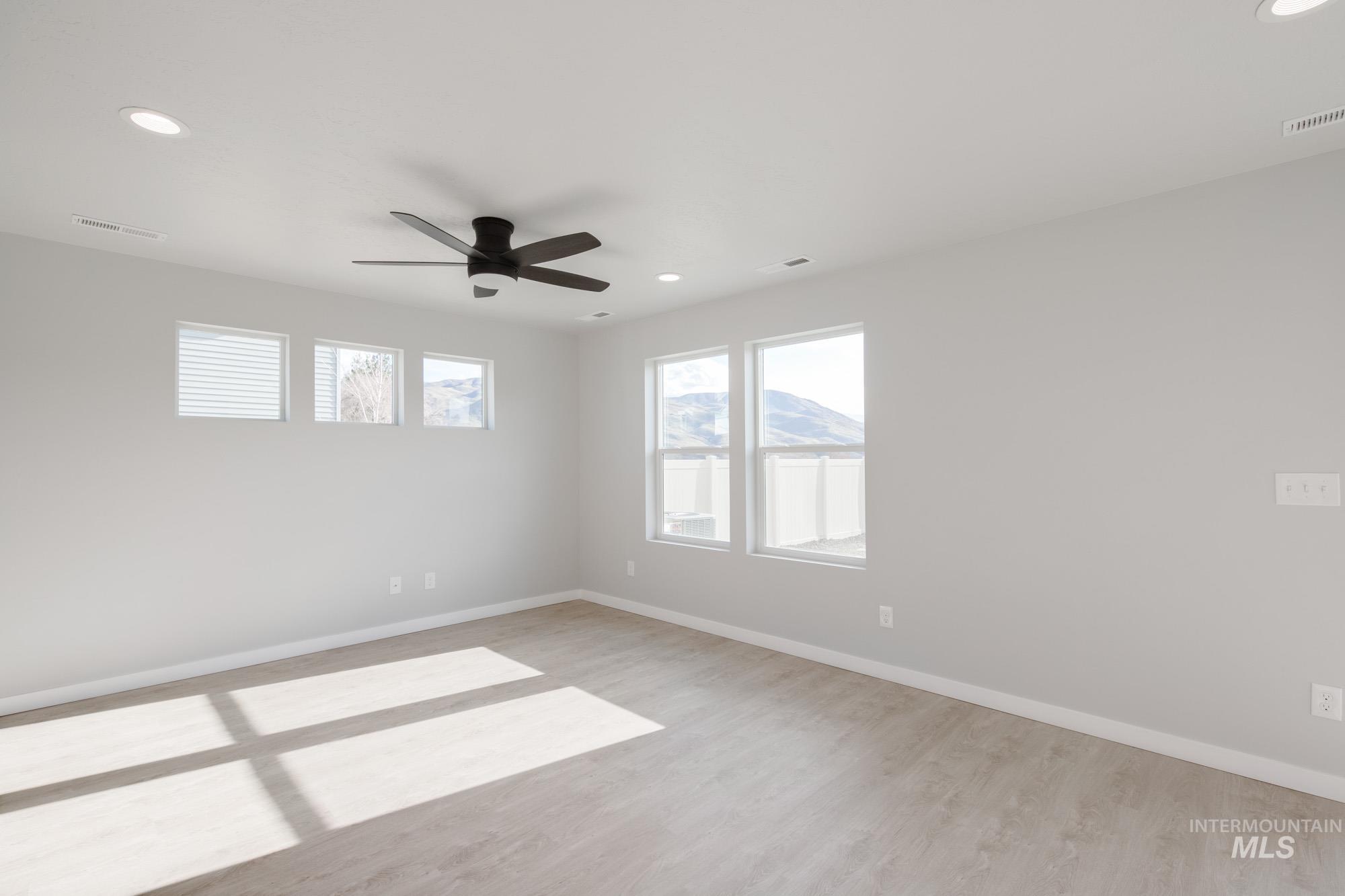 10788 Rutland Street Caldwell, ID 83605 - Photo 8 of 22 Spare room with recessed lighting, ceiling fan, plenty of natural light, and light wood-style flooring
