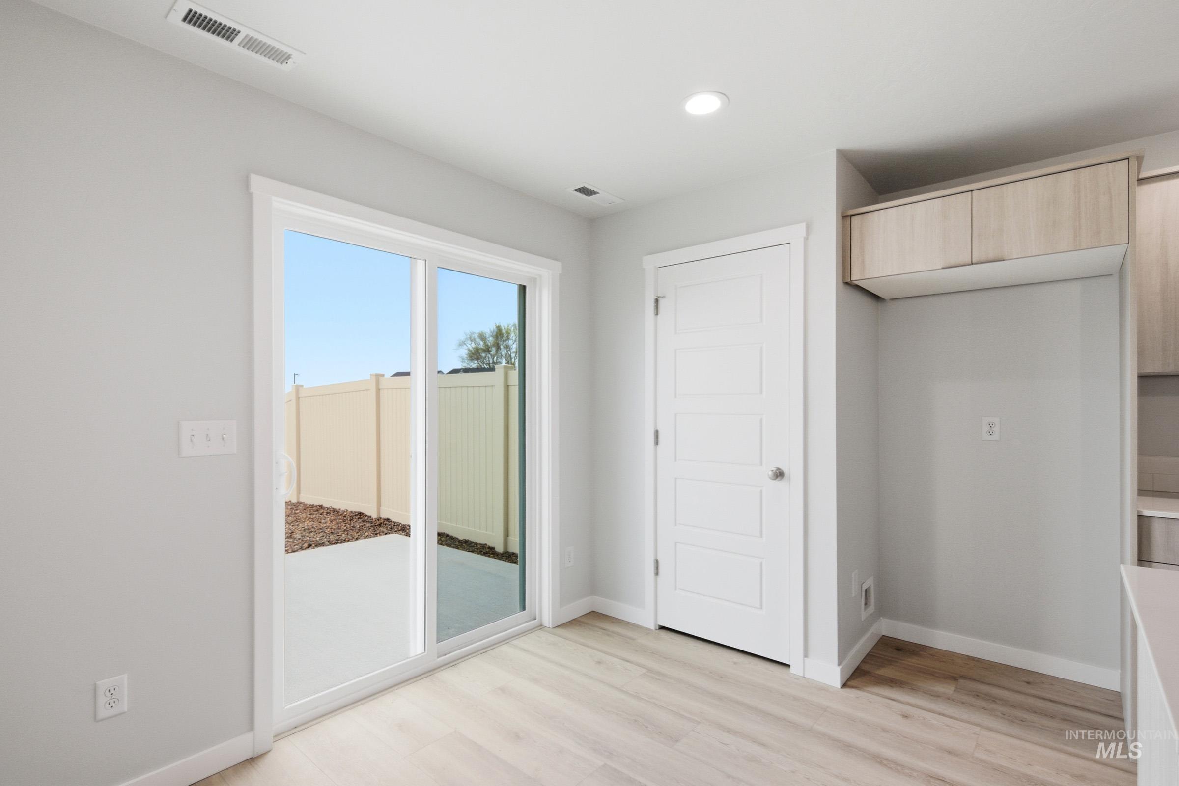 10788 Rutland Street Caldwell, ID 83605 - Photo 9 of 22 Unfurnished bedroom with access to outside, light wood-type flooring, and recessed lighting