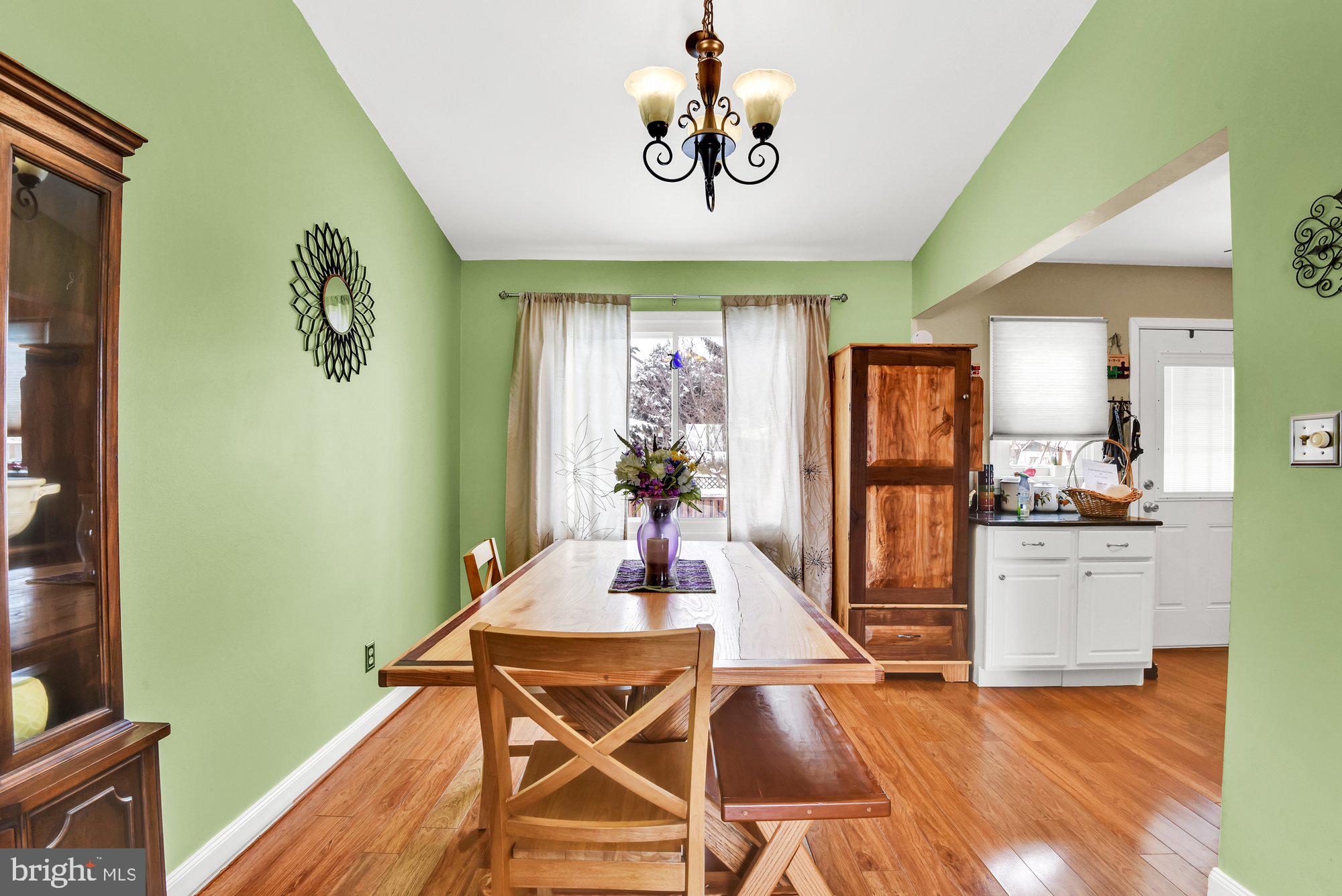 806 Uniontown Road Westminster, MD 21158 - Photo 3 of 10 a view of a dining room with furniture a chandelier and wooden floor