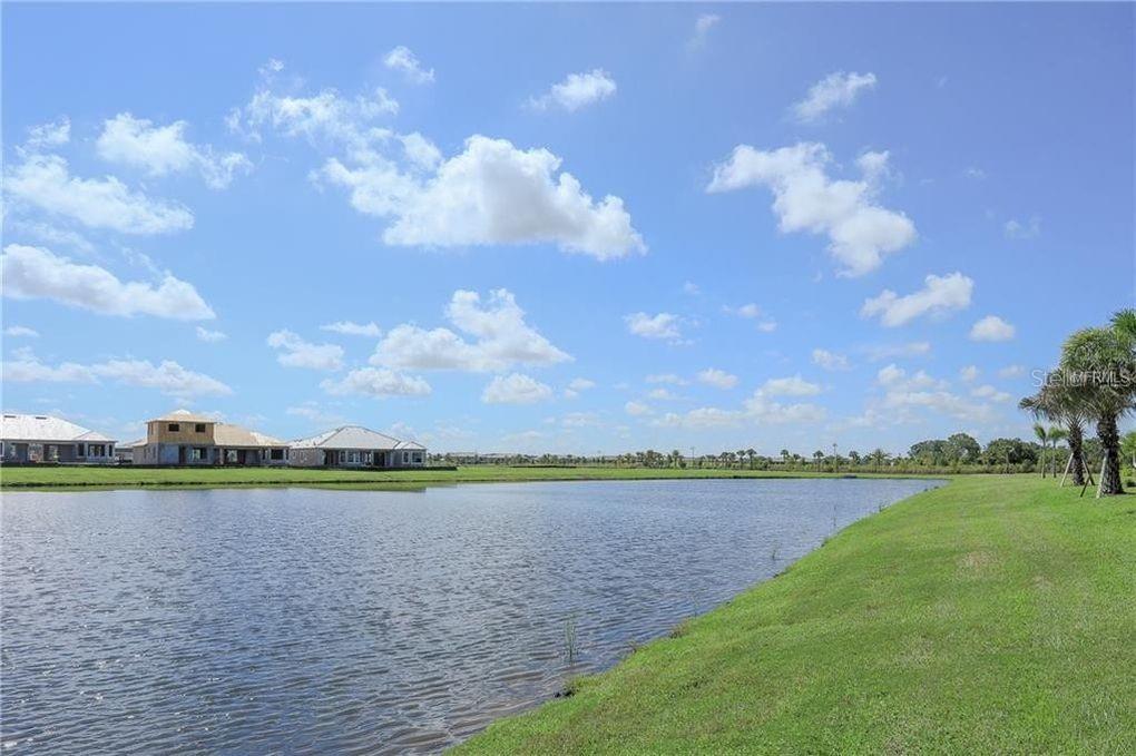 5528 Arnie Loop Lakewood Ranch, FL 34211 - Photo 32 of 59 a view of a lake and a city