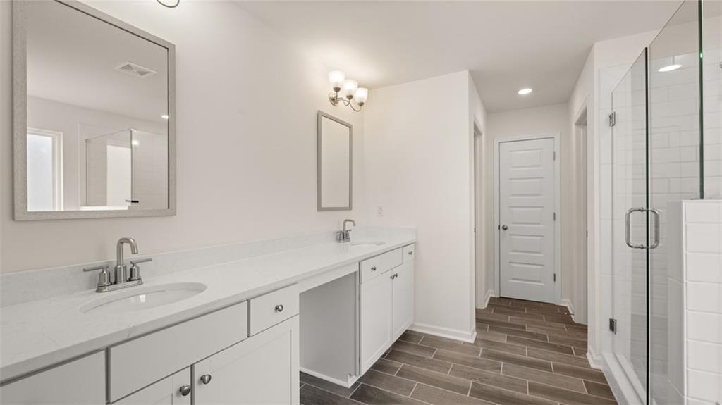 421 Hazel Drive Locust Grove, GA 30248 - Photo 20 of 28 a bathroom with a sink and a mirror