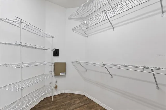 a view of walk in closet with empty racks
