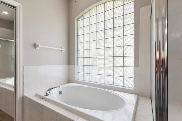 a bathroom with a bathtub and window