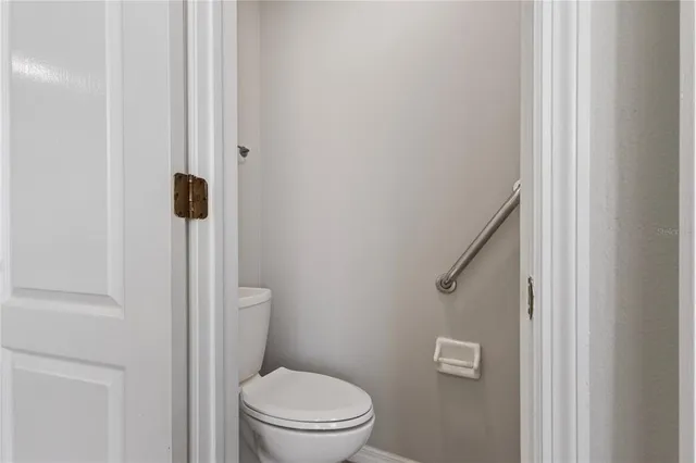 a white toilet sitting next to a shower