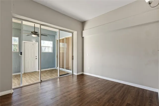 an empty room with wooden floor and a door