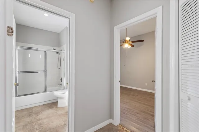 a bathroom with a shower and a glass door
