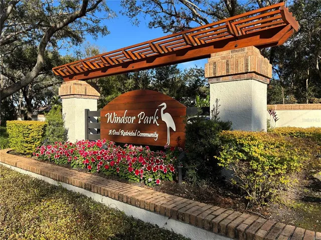 a front view of a house with a yard and wooden fence