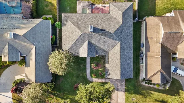 an aerial view of a house with a yard and potted plants