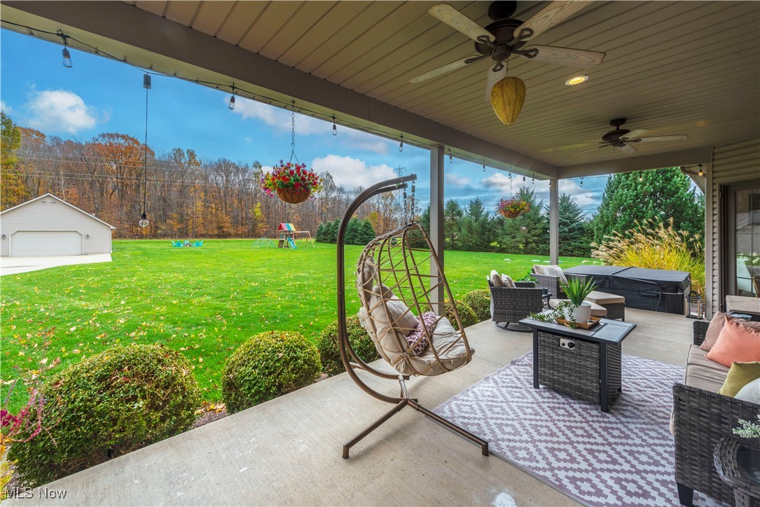 7661 Heritage Way Amherst, OH 44001 - Photo 35 of 49 View of patio with outdoor lounge area, ceiling fan, an outdoor structure, and a hot tub