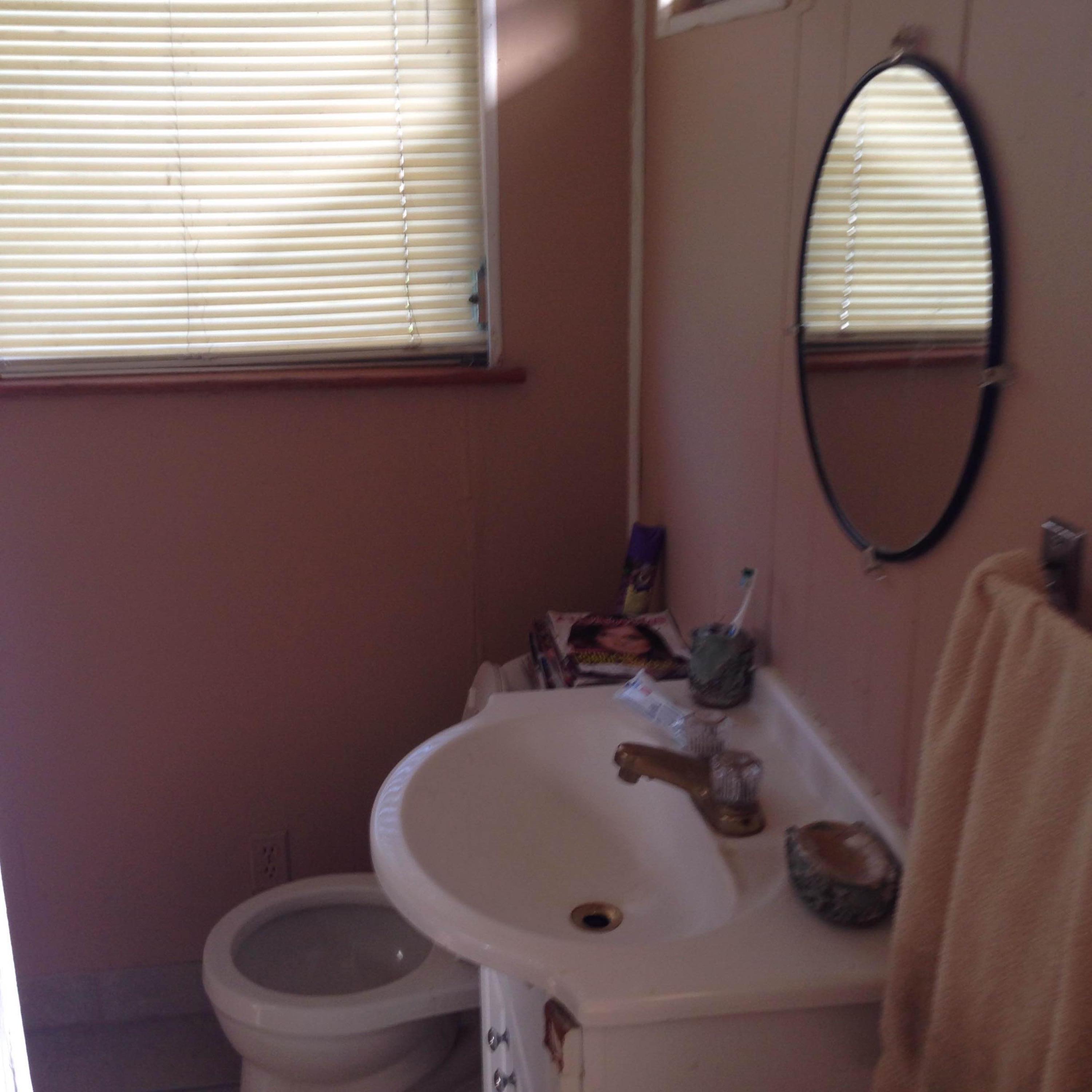 14683 Barwick Road Delray Beach, FL 33445 - Photo 2 of 6 a bathroom with a sink a toilet and a mirror