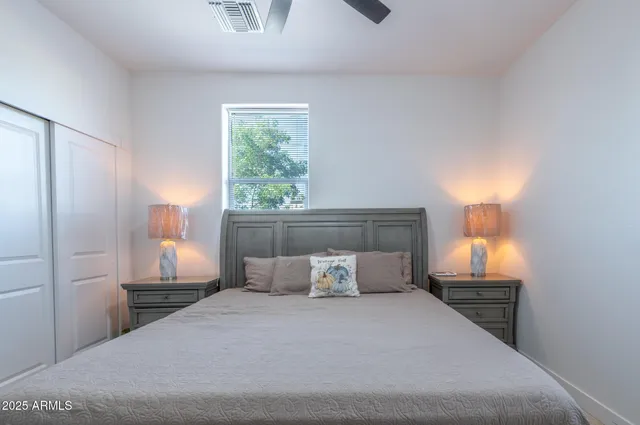 a bedroom with a large bed and a window