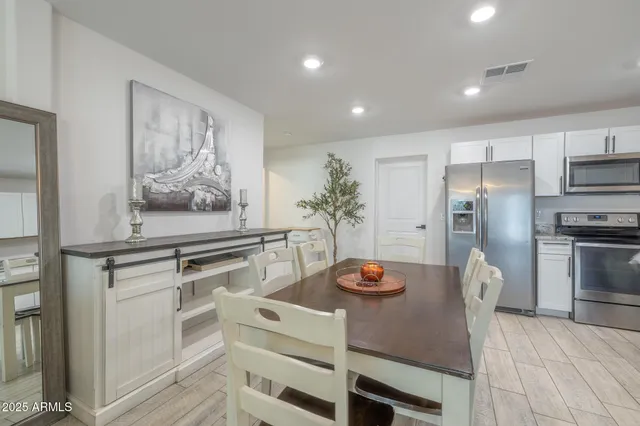 a kitchen with granite countertop white cabinets and stainless steel appliances